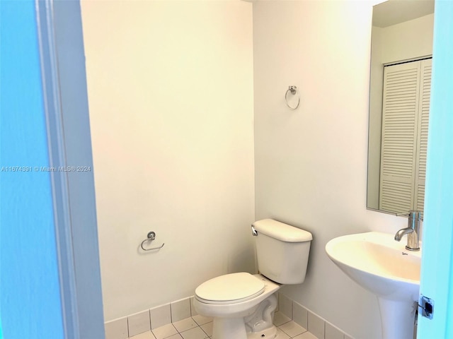 bathroom featuring sink, toilet, and tile patterned floors