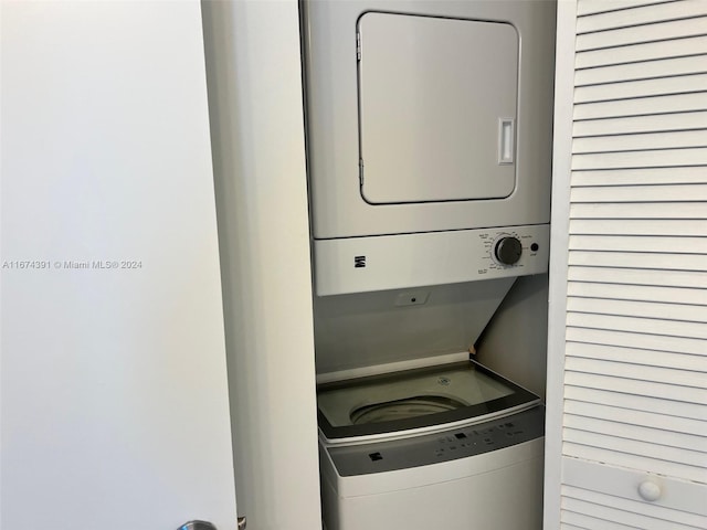 laundry area featuring stacked washer / drying machine