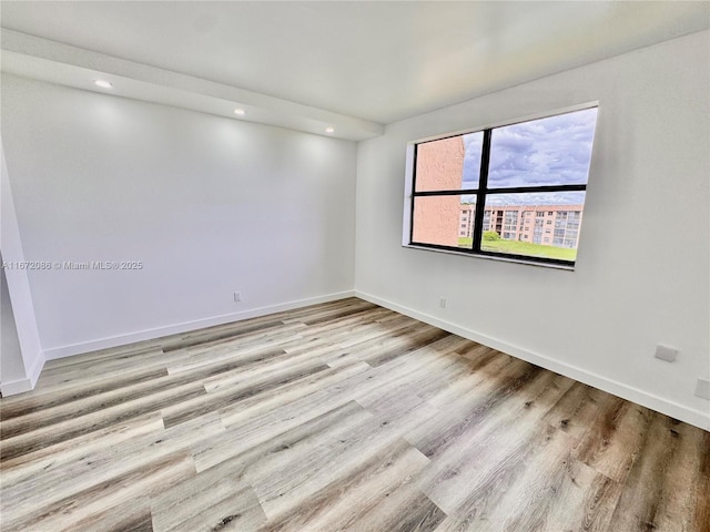 spare room featuring light hardwood / wood-style floors