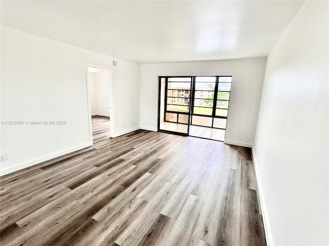 spare room with light hardwood / wood-style flooring