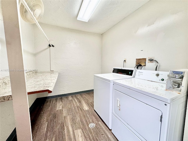 laundry area featuring wood-type flooring and washer and clothes dryer