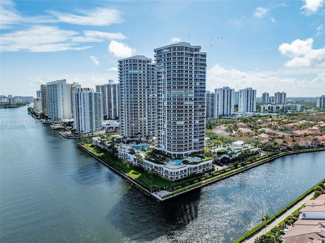 birds eye view of property with a city view and a water view