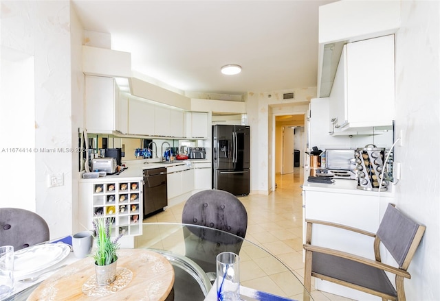 kitchen with sink, dishwasher, refrigerator with ice dispenser, white cabinets, and light tile patterned floors