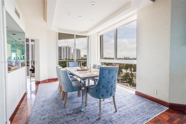 dining area with baseboards, wood finished floors, and visible vents