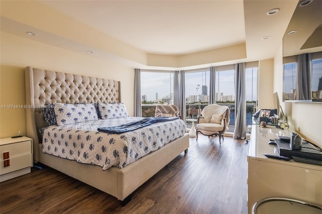 bedroom featuring dark wood-type flooring and multiple windows