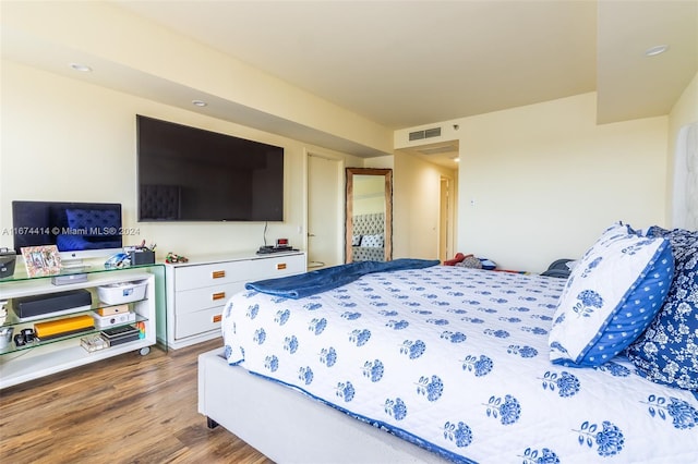 bedroom with wood finished floors and visible vents