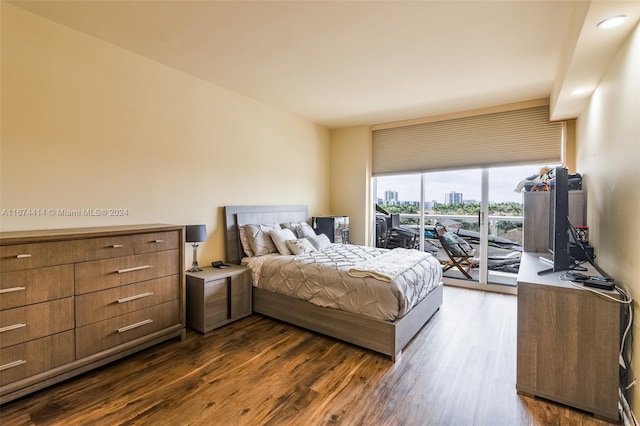 bedroom featuring access to outside and dark wood-type flooring