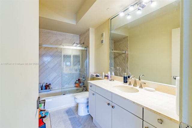 bathroom featuring shower / bath combination with glass door, toilet, visible vents, tile patterned flooring, and vanity