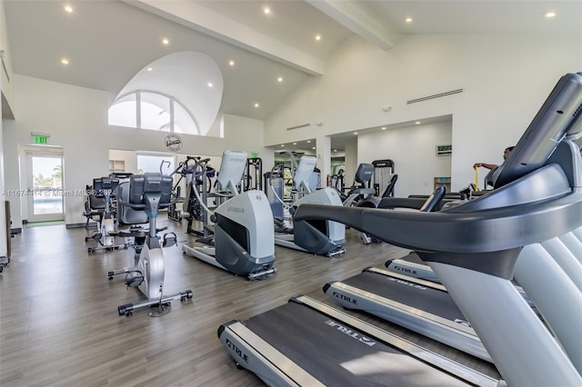 gym with wood finished floors, high vaulted ceiling, and recessed lighting