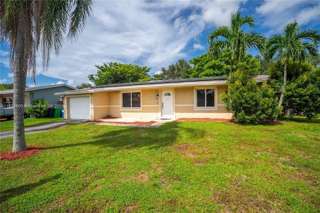 ranch-style house with a garage and a front lawn