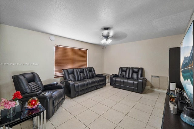 tiled living room with ceiling fan and a textured ceiling