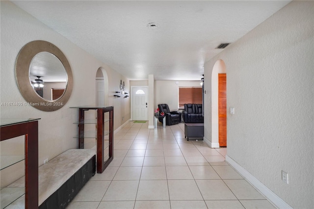 hallway featuring light tile patterned floors