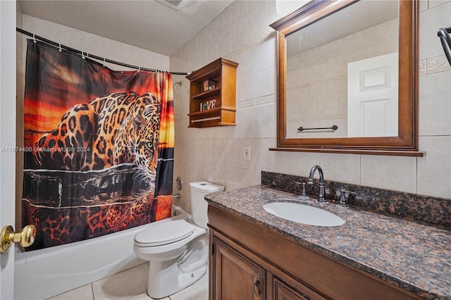 full bathroom featuring tile walls, shower / bath combo, vanity, and toilet