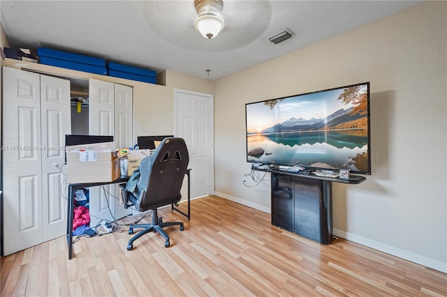 office featuring hardwood / wood-style floors and a textured ceiling