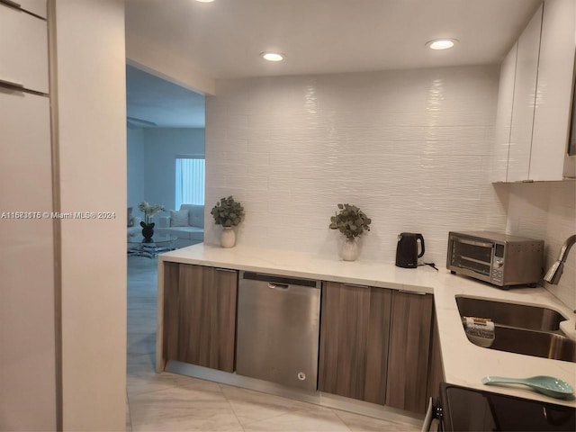 kitchen featuring stove, white cabinets, sink, dark brown cabinets, and dishwasher