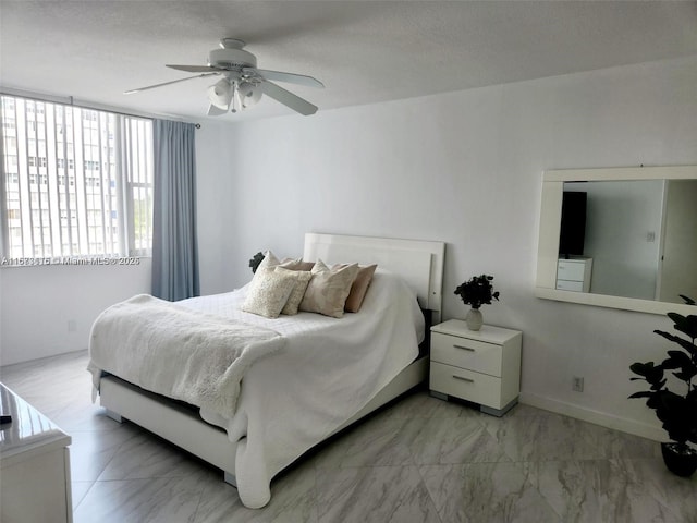 4330 Hillcrest Dr Unit 414, Hollywood, FL 33021 - bedroom featuring light marble finish flooring, a ceiling fan, and baseboards