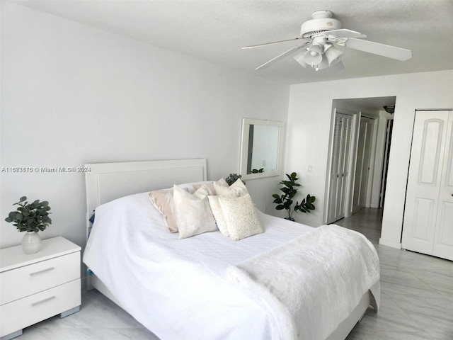 bedroom featuring a textured ceiling and ceiling fan