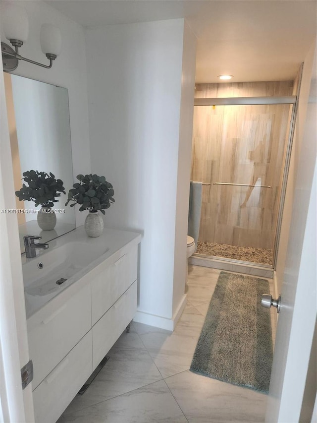 4330 Hillcrest Dr Unit 414, Hollywood, FL 33021 - bathroom featuring vanity, toilet, a stall shower, marble look tile flooring, and baseboards