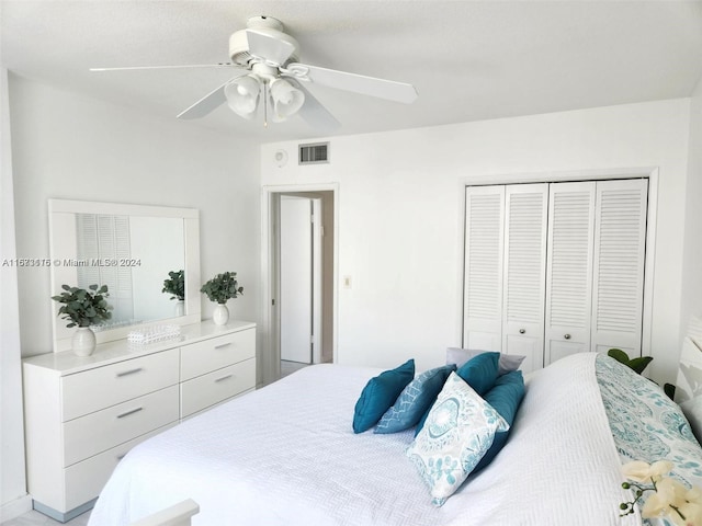 bedroom with ceiling fan and a closet