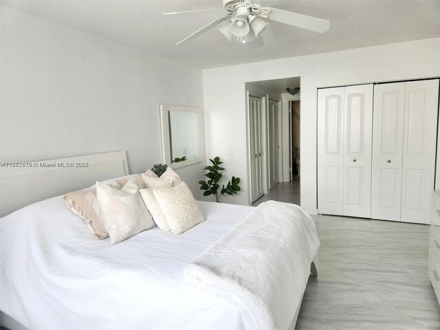 4330 Hillcrest Dr Unit 414, Hollywood, FL 33021 - bedroom featuring light marble finish floors, a ceiling fan, and a closet
