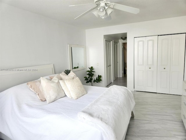 bedroom with ceiling fan and a closet