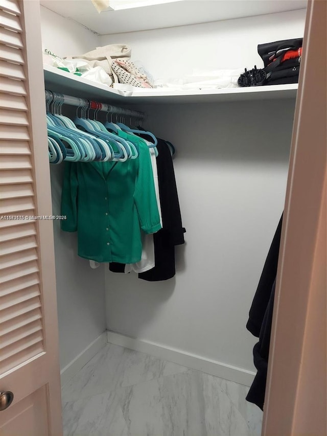 4330 Hillcrest Dr Unit 414, Hollywood, FL 33021 - walk in closet featuring marble look tile flooring