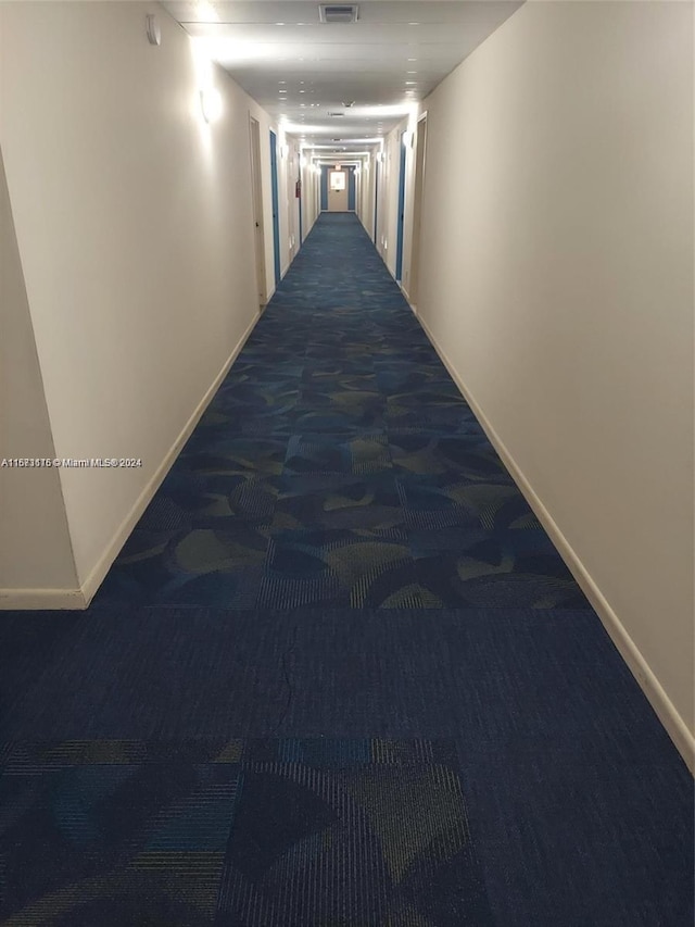 hallway with carpet floors