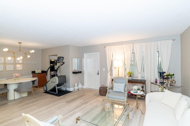 living room with hardwood / wood-style floors and a notable chandelier