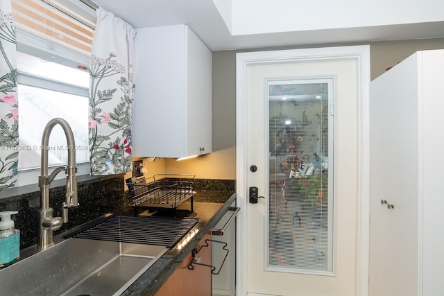 kitchen featuring white cabinets and sink