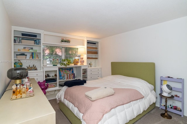 bedroom featuring a textured ceiling and carpet flooring