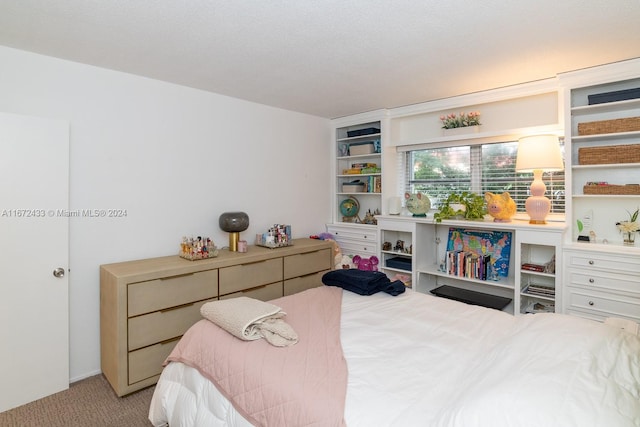 carpeted bedroom featuring a textured ceiling