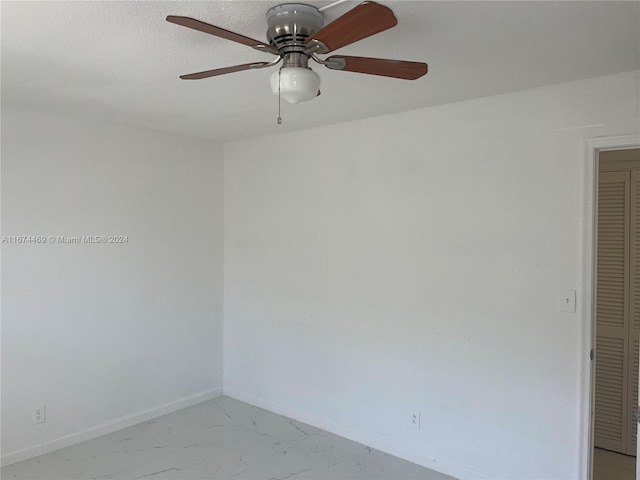 spare room featuring ceiling fan and a textured ceiling