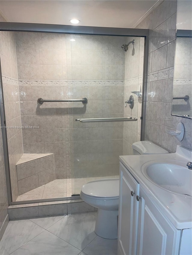 bathroom with ornamental molding, vanity, toilet, and a shower with door