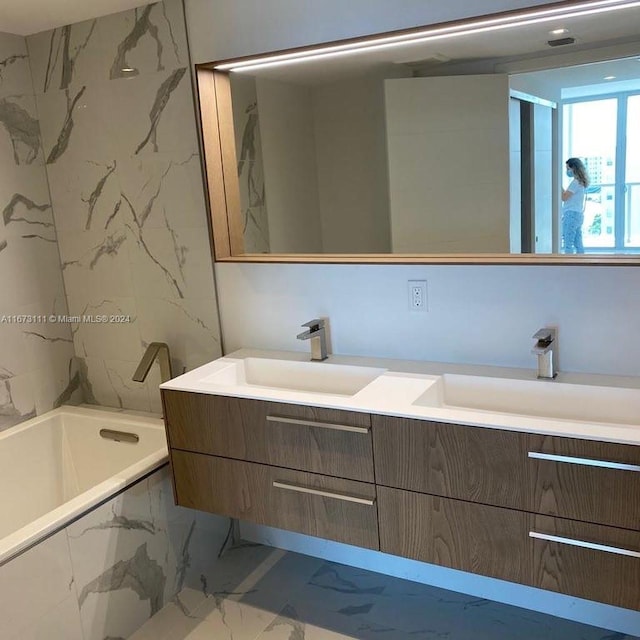 9521 E Bay Harbor Dr Unit 605, Bay Harbor Islands, FL 33154 - bathroom with marble look tile flooring, double vanity, and a tub with marble appearance