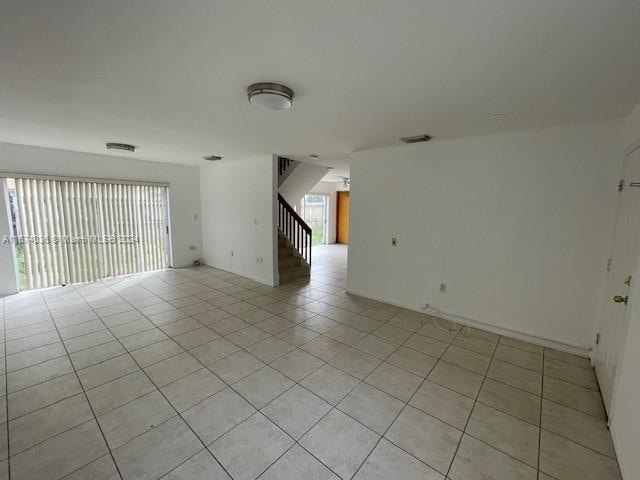 spare room featuring light tile patterned floors