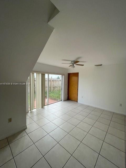 empty room with light tile patterned floors and ceiling fan