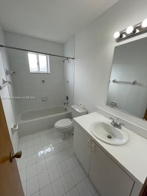 full bathroom with tile patterned floors, vanity, toilet, and tiled shower / bath combo