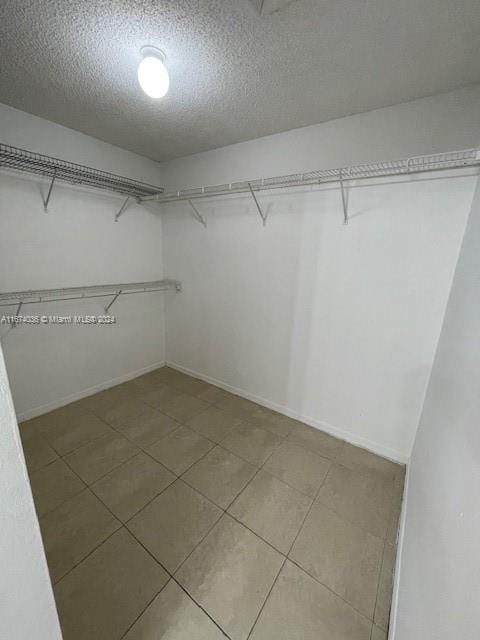 spacious closet featuring tile patterned flooring