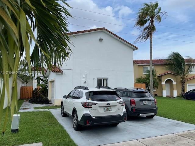 view of car parking with a lawn