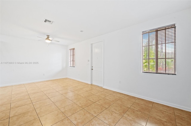 tiled empty room featuring ceiling fan