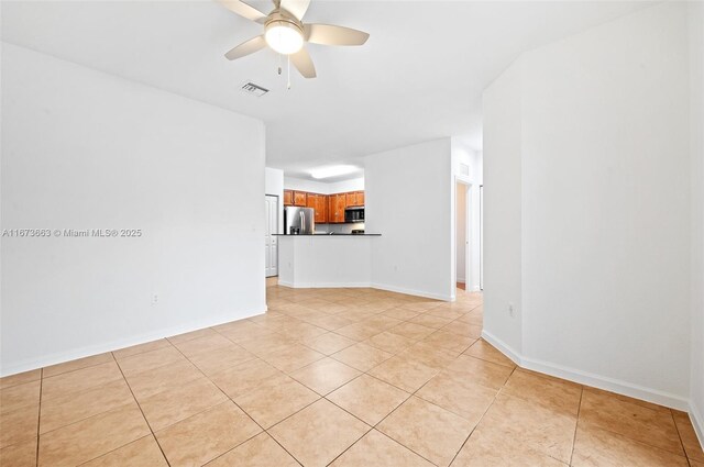 kitchen with light tile patterned flooring and appliances with stainless steel finishes