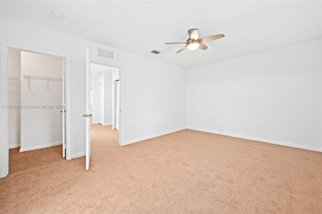 spare room featuring carpet flooring and ceiling fan