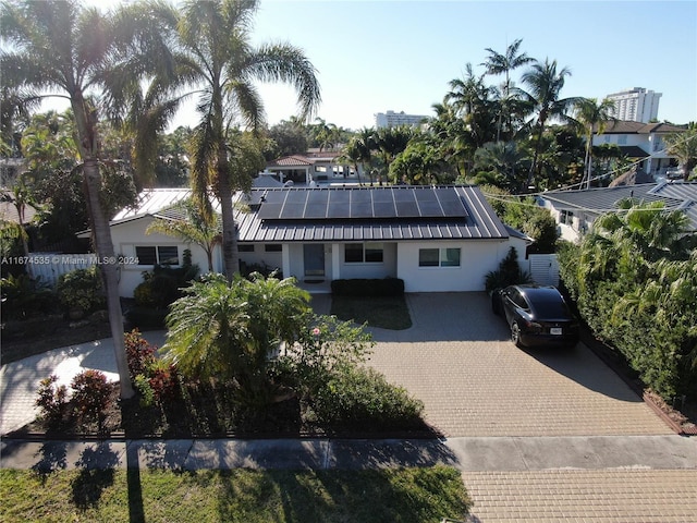 view of front of property with solar panels