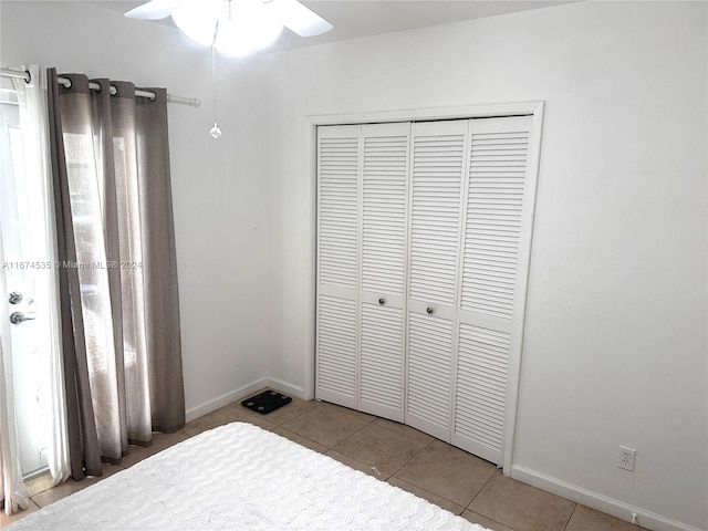 tiled bedroom with a closet and ceiling fan