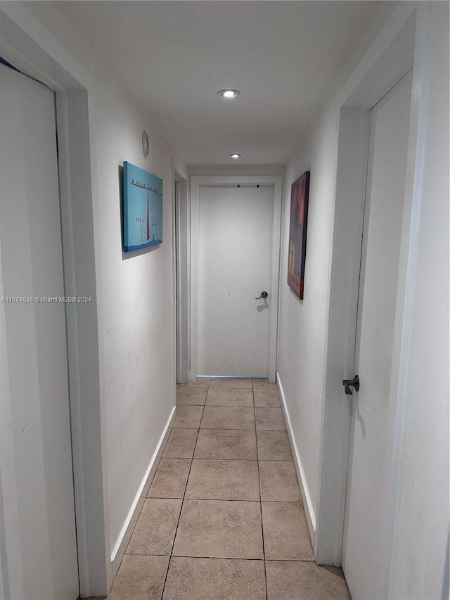 corridor with light tile patterned floors