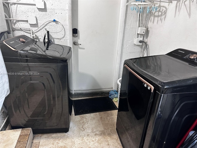 clothes washing area featuring washer / dryer