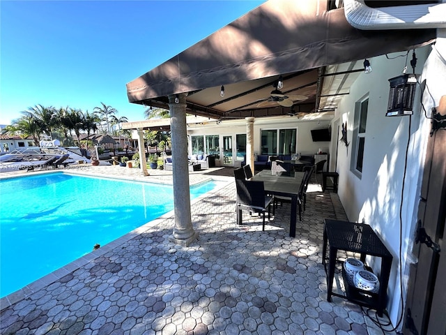 view of swimming pool with a patio and ceiling fan