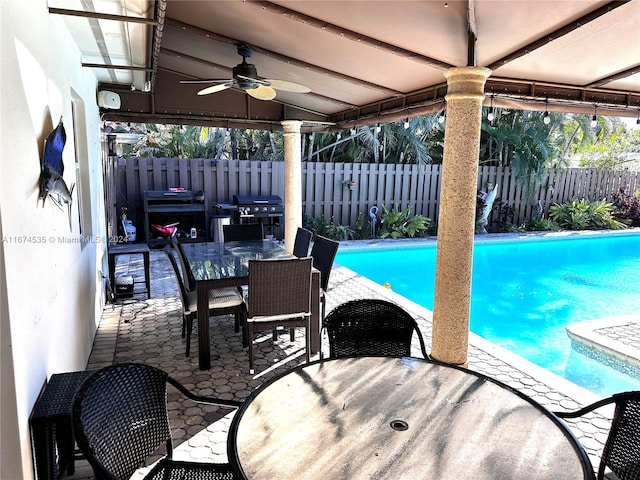 view of swimming pool featuring area for grilling, ceiling fan, and a patio area