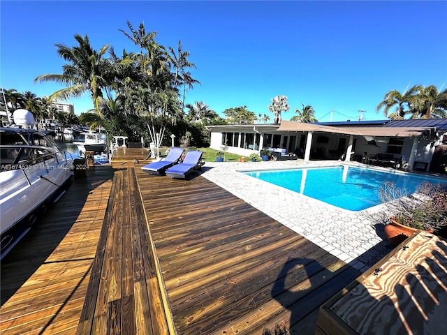 view of swimming pool with a water view and a patio area