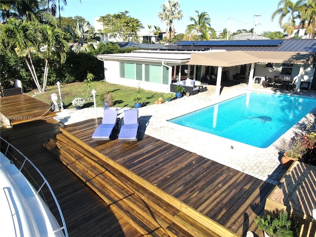 view of swimming pool with a deck, a lawn, and a patio area